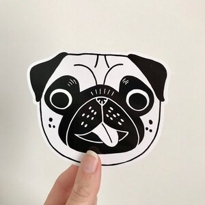 May include: Black and white illustration of a pug dog with its tongue sticking out. The pug has a happy expression on its face.