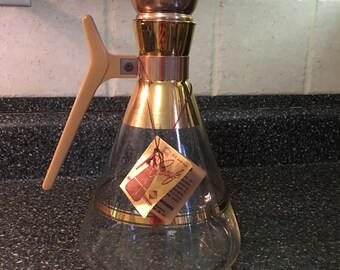 Vintage mid century Inland Carafe for Gracious Serving with 22-K gold trim. Unused, with manufacturer's instructions. Made in USA. 1950s.