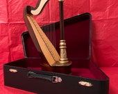 Vintage windup Harp music box in hard case. Plays Phantom of the Opera. Clear sound, excellent condition.