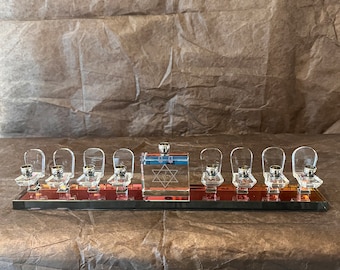 Modern crystal colored glass menorah. Amazing presentation and spread of polished crystal stand low profile candlestick holders. 9 candles.