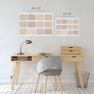 May include: A light wood desk with a lamp, a book, and a wastebasket. A gray chair sits in front of the desk. Two calendars are hanging on the wall behind the desk. The larger calendar is 36 inches by 24 inches and the smaller calendar is 24 inches by 18 inches.