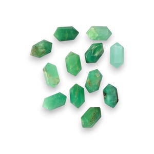 May include: A collection of twelve green gemstone points, also known as green aventurine, arranged on a white background.