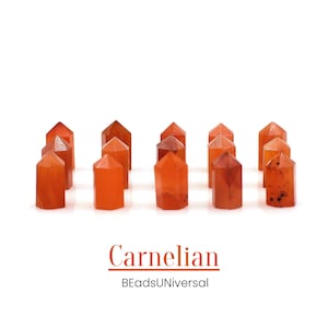 May include: Ten small, orange carnelian crystal points arranged in a row on a white background. The crystals are all about the same size and shape, and they have a smooth, polished finish. The text "Carnelian" and "BeadsUniversal" is printed below the crystals.