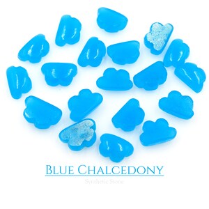 May include: A collection of 17 blue chalcedony cloud-shaped stones on a white background. The stones are smooth and polished, and they have a light blue color. The text "BLUE CHALCEDONY" and "Synthetic Stone" is printed below the stones.