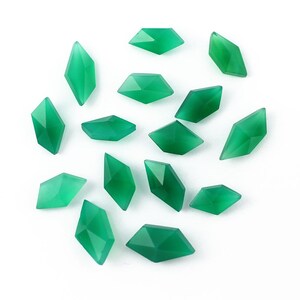 May include: A collection of 15 green gemstone beads in a diamond shape. The beads are faceted and have a translucent appearance.