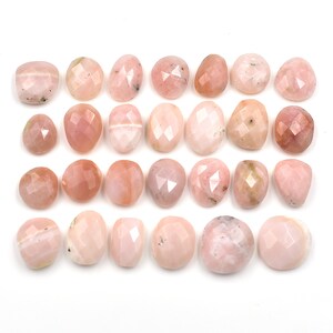 May include: Twenty-four pink opal cabochons, each with a faceted, rounded shape. The stones are arranged in four rows of six, on a white background.