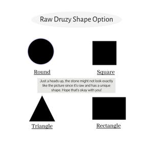 May include: An image displaying shape options for raw druzy stones. The options include a black circle labeled "Round", a black square labeled "Square", a black triangle labeled "Triangle", and a black rectangle labeled "Rectangle". Text at the center explains the stone's unique shape.