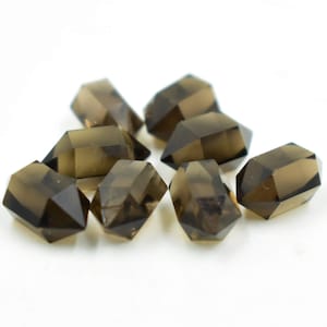 May include: A group of eight smoky quartz crystal points, each with a double-terminated shape. The crystals are a dark brown color and have a natural, unpolished finish.