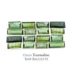 May include: A collection of 15 green tourmaline gemstones in a raw baguette cut. The stones are arranged in rows and are a mix of light and dark green hues.