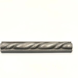 May include: A silver metal decorative trim with a twisted rope design.