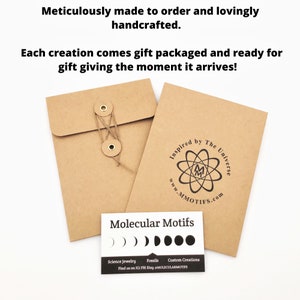 May include: A brown paper envelope with a string and two metal buttons. The envelope has a logo that says "Inspired by The Universe" and "www.MMOTIFS.com". A white card with black text says "Molecular Motifs" and has a row of five black circles. The text on the card says "Science Jewelry, Fossils, Custom Creations, Find us on IGI FB) Etsy MOLECULARMOTIFS".