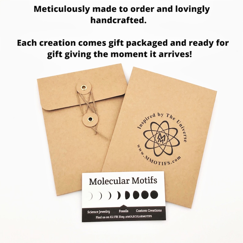 May include: A brown paper envelope with a string and two metal buttons. The envelope has a logo that says "Inspired by The Universe" and "www.MMOTIFS.com". A white card with black text says "Molecular Motifs" and has a row of five black circles. The text on the card says "Science Jewelry, Fossils, Custom Creations, Find us on IGI FB) Etsy MOLECULARMOTIFS".