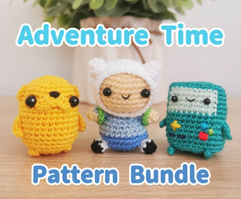 May include: Crochet pattern bundle for Adventure Time characters. The bundle includes Finn the Human, Jake the Dog, and BMO. The characters are made with yarn in yellow, blue, white, and green.