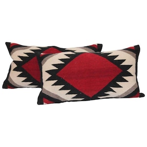 May include: Two rectangular pillows with a geometric pattern in black, white, red, and gray. The pattern features a large diamond shape in the center of each pillow.
