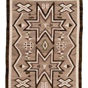 May include: A Navajo rug with a geometric pattern in shades of brown, white, and gray. The rug features a central design of two large stars with smaller stars and geometric shapes surrounding them.