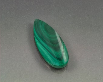 Malachite pear shape cabochon black Jade back. Forest green African material 31 mm x 13 mm x 4 mm. 20.5 carats.