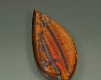 Marra Mamba Tiger eye pear-shaped cabochon polished both sides metallic brown Australia. 23 mm x 50 mm x 6 mm deep. 56.5 carats