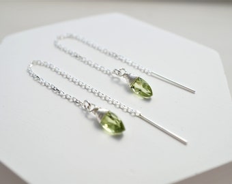 May include: A pair of silver chain earrings with green gemstone teardrop pendants.