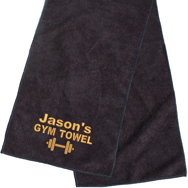 May include: Black gym towel with gold embroidery that says "Jason's Gym Towel" and a dumbbell icon.