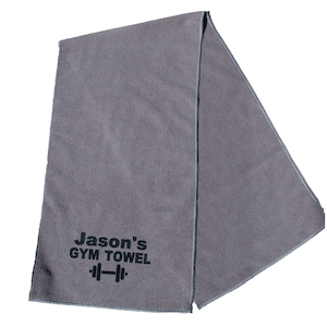 May include: Gray gym towel with black text that reads "Jason's GYM TOWEL" and a black dumbbell icon.