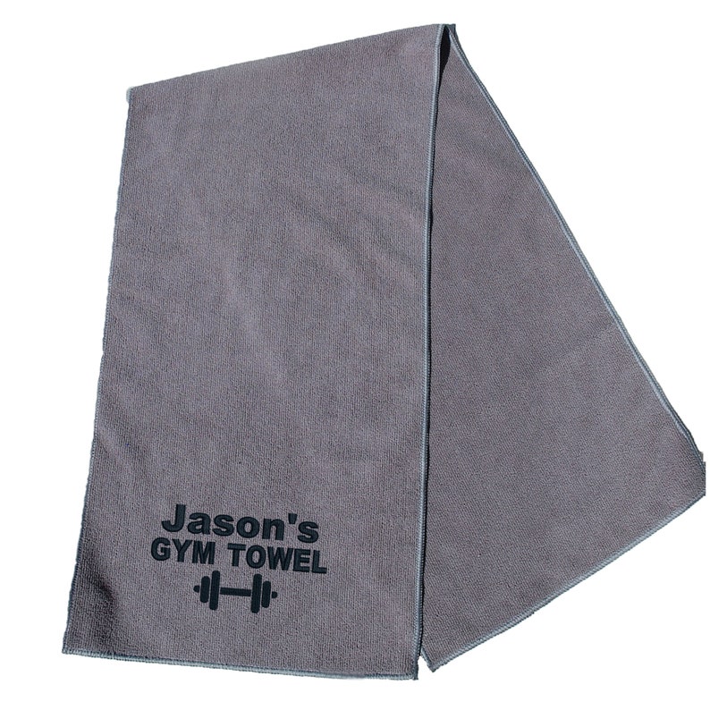May include: Gray gym towel with black text that reads "Jason's GYM TOWEL" and a black dumbbell icon.