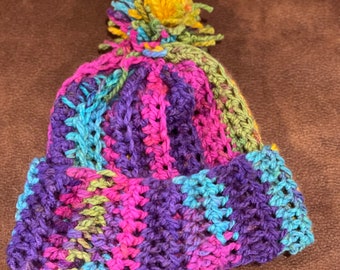 Rainbow winter beanie with a rainbow pom pom, perfect for Christmas and winter