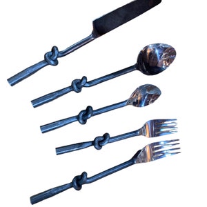 May include: Set of five silver utensils with knotted handles. The set includes a knife, two spoons, and two forks.