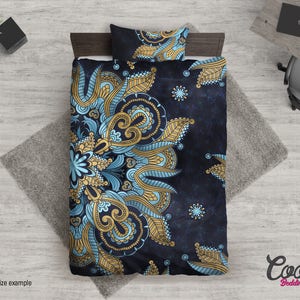 May include: A blue and gold mandala patterned duvet cover with a dark blue background. The duvet cover is on a bed with a matching pillow.