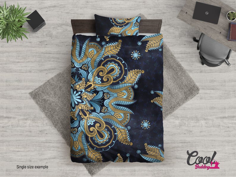 May include: A blue and gold mandala patterned duvet cover with a dark blue background. The duvet cover is on a bed with a matching pillow.