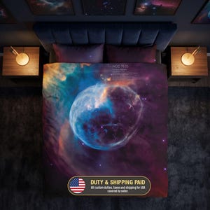 May include: A duvet cover featuring a vibrant space-themed print of the NGC 7635 Bubble Nebula in shades of deep blue, purple, and orange. The design includes small white text detailing the nebula name and scientific information on the fabric.