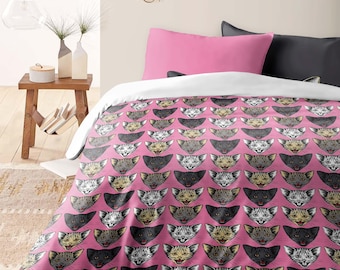 May include: Pink queen-sized duvet cover with a repeating pattern of colorful cat faces.  The duvet cover is shown on a bed with pink and gray pillows.  "QUEEN SIZE PREVIEW" is printed at the bottom of the image.