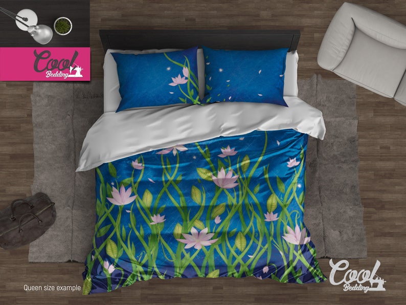 Pu&ograve; includere: Un set di biancheria da letto queen size con sfondo blu e motivo floreale. I fiori sono rosa e bianchi e le foglie sono verdi. Il set di biancheria da letto &egrave; mostrato su un pavimento di legno con una borsa di pelle marrone e una pianta in vaso.