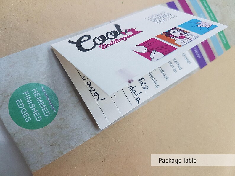May include: A white package label with the text "Cool Bedding" in black cursive lettering. The label also includes the text "Hemmed Finished Edges" in green on a white circle. The label has a price tag with the text "&pound;20 dala" in black.