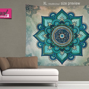 May include: A teal and blue mandala tapestry with a floral design. The tapestry is hanging on a wall above a white couch with a brown pillow.