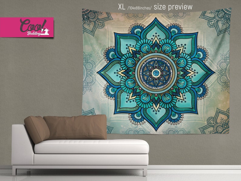 May include: A teal and blue mandala tapestry with a floral design. The tapestry is hanging on a wall above a white couch with a brown pillow.