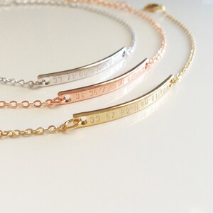 May include: Three gold, rose gold, and silver bracelets with delicate chains and engraved coordinates. The coordinates are 33 71/08/N 80-59-12, 34 35/79/N 80-59-12, and 33 57/82/N 60-01-43.
