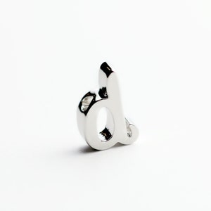 May include: Silver charm in the shape of the letter 'd'.
