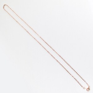 May include: A rose gold chain necklace with a lobster clasp.