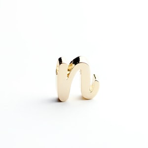 May include: A gold-colored letter 'n' charm. The letter is in a cursive style.