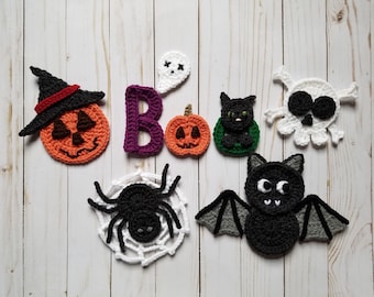 May include: A set of crocheted Halloween decorations, including a pumpkin, a ghost, a bat, a spider, a skull, a black cat, and the letter "B".