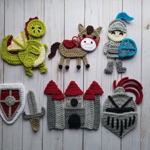 May include: A set of crocheted felt toys featuring a dragon, a horse, a knight, a castle, a sword, a shield, and a helmet. The toys are all in shades of green, brown, red, and gray.