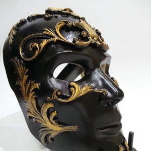 Mask black prince from venice. Cosplay Halloween decorative as an ornament. The human face Venetian mask