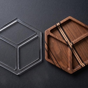 May include: A set of three ceramic mugs with a speckled, matte finish. The mugs are in shades of cream, light gray, and dark gray. Each mug has a simple, minimalist design and a rounded handle.