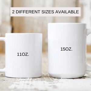 May include: Two white ceramic mugs with black text. The smaller mug says "11oz." and the larger mug says "15oz."