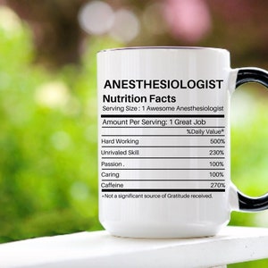 May include: White ceramic mug with a black handle. The mug has a nutrition facts label that says "Anesthesiologist" with a list of qualities and their daily value percentages. The qualities listed are: Hard Working, Unrivaled Skill, Passion, Caring, and Caffeine.