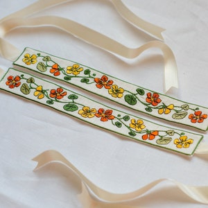 Embroidered 18th century garters with nasturtiums for stockings.