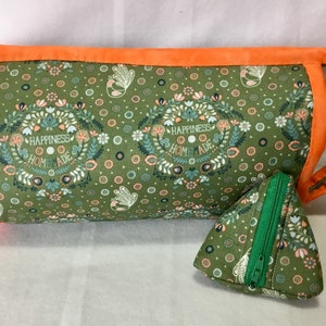 May include: A green fabric zippered pouch with a floral pattern and the text "Happiness Homemade". The pouch has an orange trim and a smaller green zippered pouch with the same pattern.