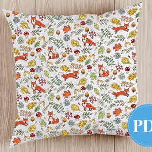 May include: A white pillow with a repeating pattern of orange foxes, leaves, and flowers. The pillow is perfect for adding a touch of autumn to your home decor.