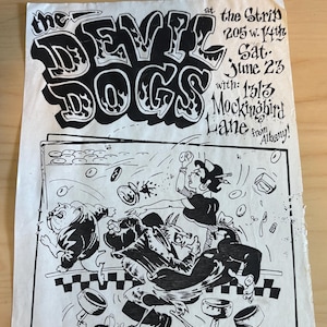 May include: A black and white concert flyer for "The Devil Dogs" at "The Strip" on June 23rd, with "1513 Mockingbird Lane from Albany!" The flyer features cartoon illustrations of a chaotic scene with figures and objects.