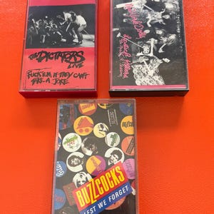 May include: A set of three ceramic mugs with a speckled, matte finish. The mugs are in shades of cream, light gray, and dark gray. Each mug has a simple, minimalist design, perfect for coffee or tea.